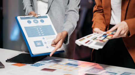 Creative team web designer feel happy work complete Teamwork planning application to analyzing projects overtime in the lamplight.